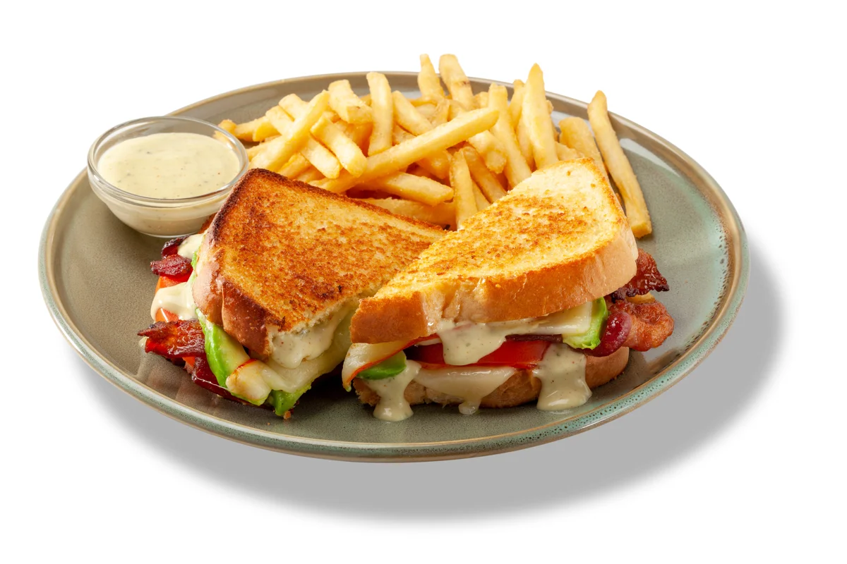 Use Avocado Ranch Dressing to infuse classic sandwiches with a little Southwestern flair. In this Smokey Avocado, Bacon & Tomato Grilled Cheese Sandwich, a generous portion of the dressing is applied to both slices of brioche, sandwiching a build of smoked Gouda, Swiss, applewood-smoked bacon, tomato and avocado slices. Acknowledge the crave factor of the dressing by adding a cupped portion for dipping. 